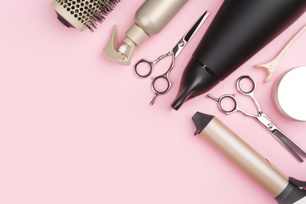 Professional,hairdressing,tools,on,pink,background,with,copy,space